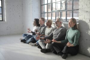Employees participating in a mindfulness session in a modern office setting