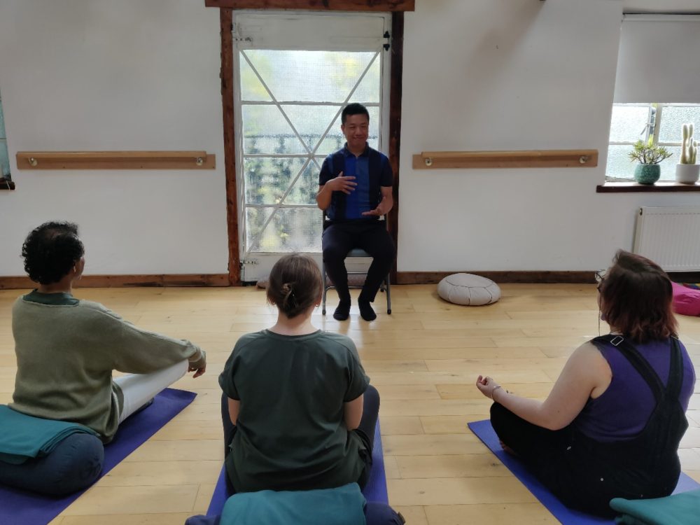Simon Chan leading a community mindfulness session in Crystal Palace, London